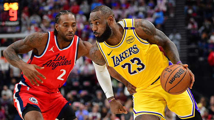 Feb 4, 2025; Inglewood, California, USA; Los Angeles Lakers forward LeBron James (23) moves the ball against Los Angeles Clippers forward Kawhi Leonard (2) during the second half at Intuit Dome. Mandatory Credit: Gary A. Vasquez-Imagn Images