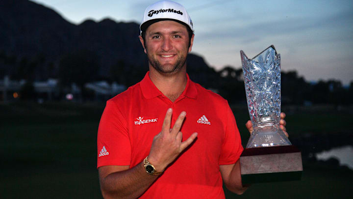 Jan 21, 2018; La Quinta, CA, USA; Jon Rahm gives the forks up gesture for his alma mater Arizona State University while holding the trophy after the final round of the CareerBuilder Challenge golf tournament at PGA West TPC Stadium Course. Mandatory Credit: Joe Camporeale-Imagn Images