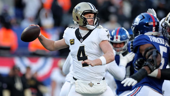 Dec 8, 2024; East Rutherford, New Jersey, USA; New Orleans Saints quarterback Derek Carr (4) drops back to pass against the New York Giants during the third quarter at MetLife Stadium. Mandatory Credit: Brad Penner-Imagn Images