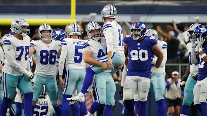 Dallas Cowboys long snapper Trent Sieg lifts up kicker Brandon Aubrey after his game-winning field goal 