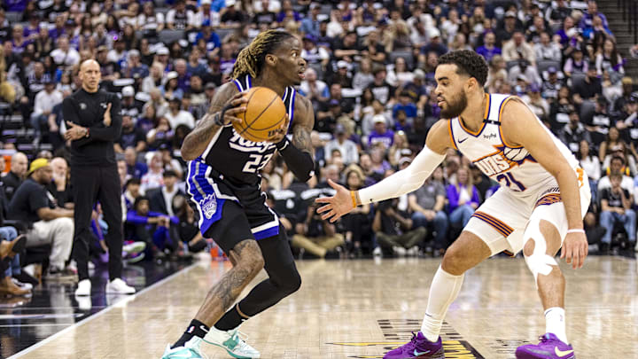 Apr 13, 2025; Sacramento, California, USA;  Sacramento Kings guard Keon Ellis (23) is defended by Phoenix Suns guard Tyus Jones (21) during the first quarter at Golden 1 Center. Mandatory Credit: John Hefti-Imagn Images