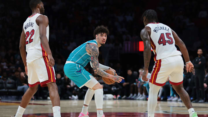 Charlotte Hornets guard LaMelo Ball (1) protects the basketball from Miami Heat forward Andrew Wiggins 