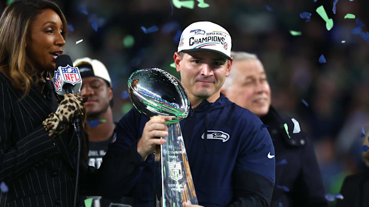 Feb 8, 2026; Santa Clara, CA, USA; Seattle Seahawks head coach Mike MacDonald celebrates with the Vince Lombardi trophy on the podium after defeating the New England Patriots in Super Bowl LX at Levi's Stadium.