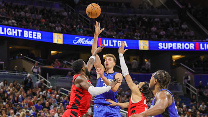 Apr 1, 2024; Orlando, Florida, USA; Orlando Magic forward Franz Wagner (22) shoots the ball over Portland Trail Blazers center Deandre Ayton (2) and guard Dalano Banton (5) during the second half at Amway Center. Mandatory Credit: Mike Watters-Imagn Images Apr 1, 2024; Orlando, Florida, USA; Orlando Magic forward Franz Wagner (22) shoots the ball over Portland Trail Blazers center Deandre Ayton (2) and guard Dalano Banton (5) during the second half at Amway Center. Mandatory Credit: Mike Watters-Imagn Images
