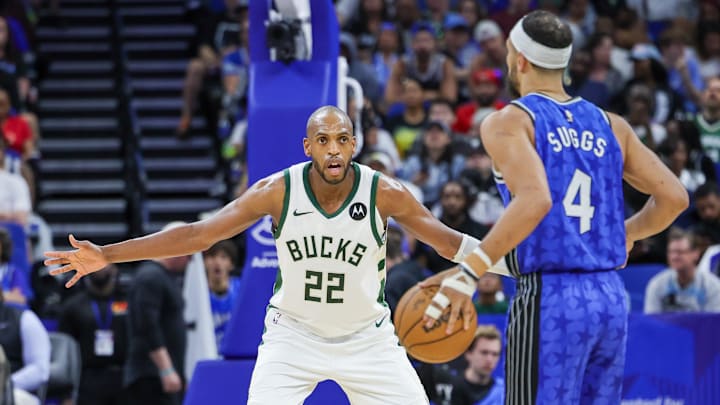 Apr 14, 2024; Orlando, Florida, USA; Milwaukee Bucks forward Khris Middleton (22) defends Orlando Magic guard Jalen Suggs (4) during the second quarter at KIA Center. Mandatory Credit: Mike Watters-Imagn Images