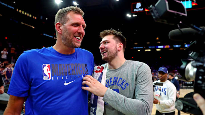 Dallas Mavericks guard Luka Doncic (77) greets former player Dirk Nowitzki after beating the Phoenix Suns in game seven of the second round for the 2022 NBA playoffs at Footprint Center.