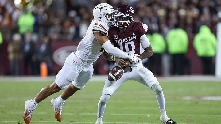 Texas Longhorns linebacker Trey Moore (8) strips the ball away from Texas A&M Aggies quarterback Marcel Reed (10) during the fourth quarter at Kyle Field. Texas Longhorns linebacker Trey Moore (8) strips the ball away from Texas A&M Aggies quarterback Marcel Reed (10) during the fourth quarter at Kyle Field.