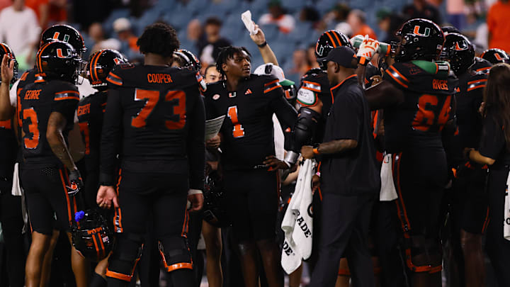 Oct 26, 2024; Miami Gardens, Florida, USA; Miami Hurricanes quarterback Cam Ward (1) looks on from the sideline during a timeout against the Florida State Seminoles in the fourth quarter at Hard Rock Stadium. Mandatory Credit: Sam Navarro-Imagn Images