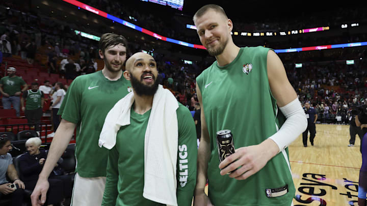 Jan 25, 2024; Miami, Florida, USA; Boston Celtics center Kristaps Porzingis (right), guard Derrick White (center) and center Luke Kornet (left) look on after the game against the Miami Heat at Kaseya Center. Mandatory Credit: Sam Navarro-Imagn Images
