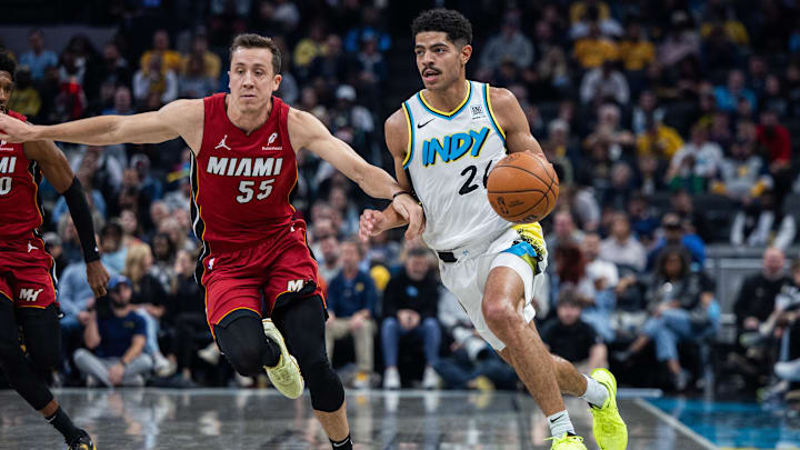 Nov 17, 2024; Indianapolis, Indiana, USA; Indiana Pacers guard Ben Sheppard (26) dribbles the ball while Miami Heat forward Duncan Robinson (55) defends in the first half at Gainbridge Fieldhouse. Mandatory Credit: Trevor Ruszkowski-Imagn Images