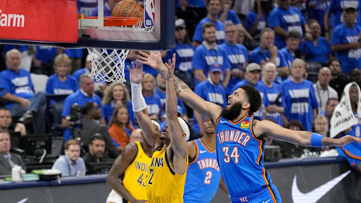 Jun 8, 2025; Oklahoma City, Oklahoma, USA; Indiana Pacers guard Andrew Nembhard (2) and Oklahoma City Thunder forward Kenrich Williams (34) battle for the rebound during the second quarter of game two of the 2025 NBA Finals at Paycom Center. Mandatory Credit: Kyle Terada-Imagn Images
