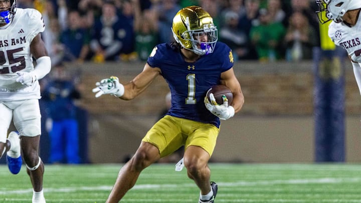 Sep 13, 2025; South Bend, Indiana, USA; Notre Dame Fighting Irish wide receiver Jaden Greathouse (1) runs with the ball during the second half against the Texas A&M Aggies at Notre Dame Stadium. Sep 13, 2025; South Bend, Indiana, USA; Notre Dame Fighting Irish wide receiver Jaden Greathouse (1) runs with the ball during the second half against the Texas A&M Aggies at Notre Dame Stadium.