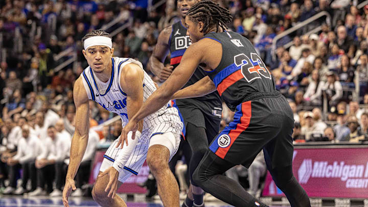 Nov 28, 2025; Detroit, Michigan, USA; Detroit Pistons guard Jaden Ivey (23) defends against Orlando Magic guard Anthony Black (0) during the first quarter at Little Caesars Arena. Mandatory Credit: David Reginek-Imagn Images
