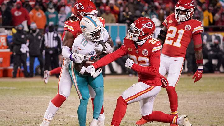 Jan 13, 2024; Kansas City, Missouri, USA; Miami Dolphins wide receiver Tyreek Hill (10) is stopped by Kansas City Chiefs linebacker Nick Bolton (32) as cornerback Trent McDuffie (22) tries to punch the football from his grasp in a 2024 AFC wild card game at GEHA Field at Arrowhead Stadium. Mandatory Credit: Denny Medley-USA TODAY Sports Jan 13, 2024; Kansas City, Missouri, USA; Miami Dolphins wide receiver Tyreek Hill (10) is stopped by Kansas City Chiefs linebacker Nick Bolton (32) as cornerback Trent McDuffie (22) tries to punch the football from his grasp in a 2024 AFC wild card game at GEHA Field at Arrowhead Stadium. Mandatory Credit: Denny Medley-USA TODAY Sports