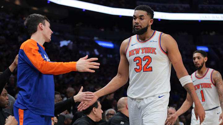 Mar 2, 2025; Miami, Florida, USA; New York Knicks center Karl-Anthony Towns (32) high-fives with teammates during the second quarter against the Miami Heat at Kaseya Center. Mandatory Credit: Sam Navarro-Imagn Images