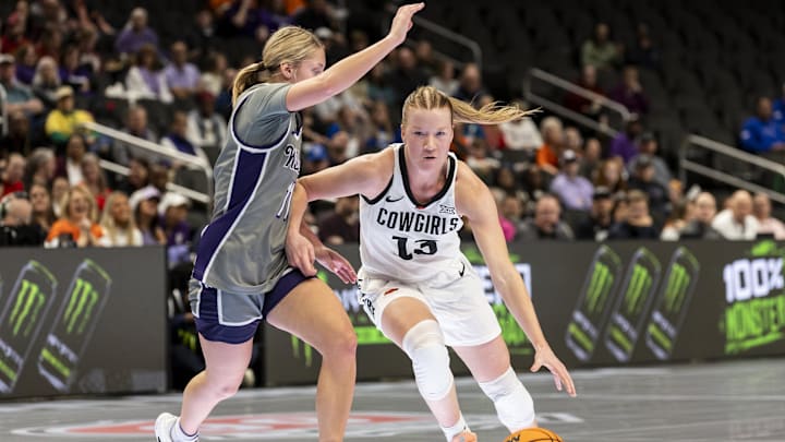Mar 6, 2026; Kansas City, MO, USA; Oklahoma State Cowgirls guard Haleigh Timmer (13) attempts to edge around Kansas State Wildcats guard Taryn Sides (11) during the first half at T-Mobile Center. Mandatory Credit: Nick Tre. Smith-Imagn Images Mar 6, 2026; Kansas City, MO, USA; Oklahoma State Cowgirls guard Haleigh Timmer (13) attempts to edge around Kansas State Wildcats guard Taryn Sides (11) during the first half at T-Mobile Center. Mandatory Credit: Nick Tre. Smith-Imagn Images
