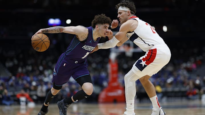 Dec 19, 2024; Washington, District of Columbia, USA; Charlotte Hornets guard LaMelo Ball (1) drives to the basket as Washington Wizards forward Corey Kispert (24) defends in the second quarter at Capital One Arena. Mandatory Credit: Geoff Burke-Imagn Images
