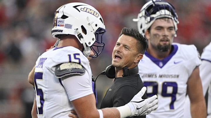 Sep 5, 2025; Louisville, Kentucky, USA;  James Madison Dukes head coach Bob Chesney talks with tight end Lacota Dippre (15) during the first quarter against the Louisville Cardinals at L&N Federal Credit Union Stadium. Mandatory Credit: Jamie Rhodes-Imagn Images