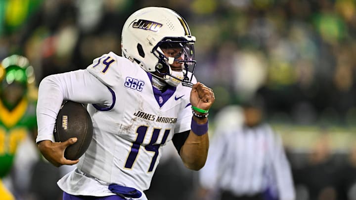 Dec 20, 2025; Eugene, Ore.; James Madison quarterback Alonza Barnett III (14) rushes against Oregon.