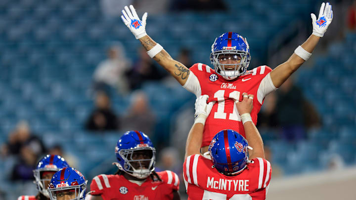 Mississippi Rebels wide receiver Jordan Watkins (11) is hoisted up by offensive lineman Reece McIntyre (56) for his touchdown score during the fourth quarter of the TaxSlayer Gator Bowl Thursday, Jan. 2, 2025 at EverBank Stadium in Jacksonville, Fla. Ole Miss defeated Duke 52-20. [Corey Perrine/Florida Times-Union]