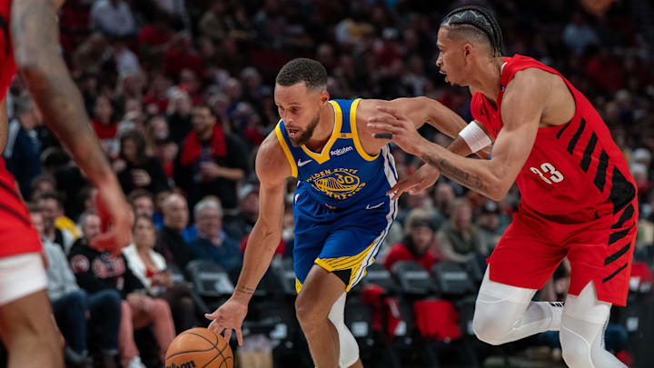 Oct 23, 2024; Portland, Oregon, USA;  Golden State Warriors point guard Stephen Curry (30) dribbles the ball against Portland Trailblazers forward Toumani Camara (33) during the second half at Moda Center. Mandatory Credit: Stephen Brashear-Imagn Images
