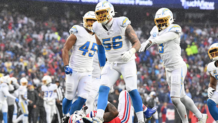 Dec 3, 2023; Foxborough, Massachusetts, USA; Los Angeles Chargers defensive end Morgan Fox (56) reacts after tackling New England Patriots running back Ezekiel Elliott (15) during the first half at Gillette Stadium. Dec 3, 2023; Foxborough, Massachusetts, USA; Los Angeles Chargers defensive end Morgan Fox (56) reacts after tackling New England Patriots running back Ezekiel Elliott (15) during the first half at Gillette Stadium.