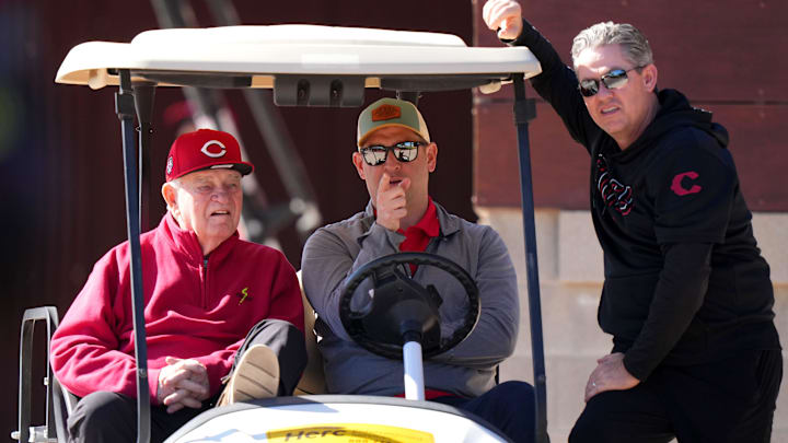 From left; Cincinnati Reds CEO Bob Castellini, president of baseball operations Nick Krall and senior vice president and general manager Brad Meador talk during spring training workouts , Monday, Feb. 19, 2024, at the team's spring training facility in Goodyear, Ariz.