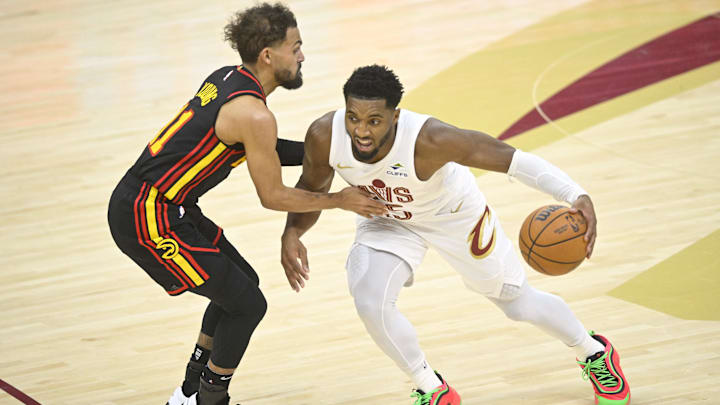 Nov 27, 2024; Cleveland, Ohio, USA; Cleveland Cavaliers guard Donovan Mitchell (45) brings the ball up court beside Atlanta Hawks guard Trae Young (11) in the fourth quarter at Rocket Mortgage FieldHouse. Mandatory Credit: David Richard-Imagn Images