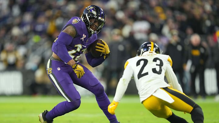 Dec 21, 2024; Baltimore, Maryland, USA; Baltimore Ravens running back Derrick Henry (22) is defended by Pittsburgh Steelers safety Damontae Kazee (23) in the first quarter at M&T Bank Stadium.
