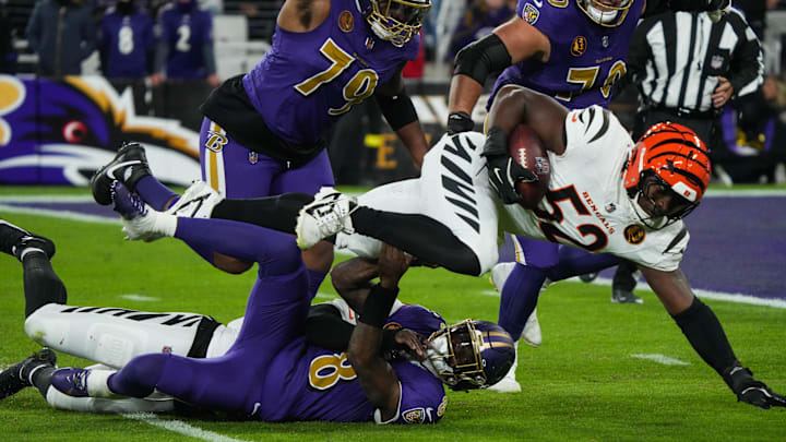 Bengals Joseph Ossai (58) helps take down Ravens Lamar Jackson (8) for Bengals Cedric Johnson (52) to gain possession of the ball during their game against the Ravens at M&T Bank Stadium on Thanksgiving Thursday November 27, 2025.