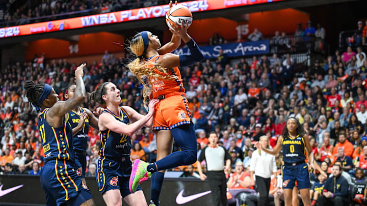 Uncasville, Connecticut, USA; Connecticut Sun guard DiJonai Carrington shoots the ball over Indiana Fever guard Caitlin Clark.