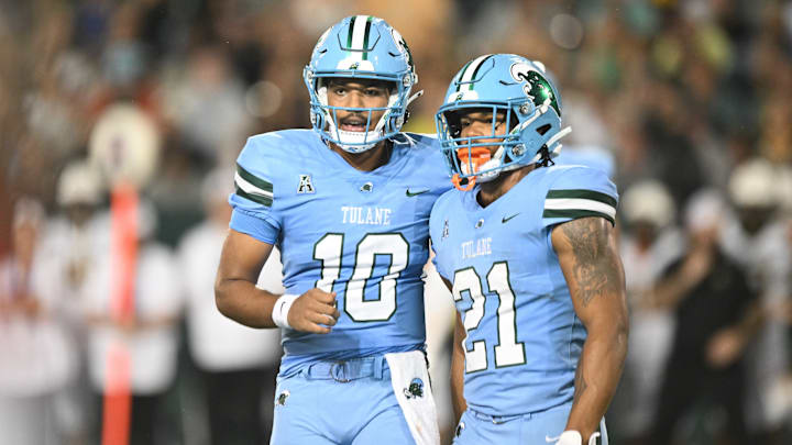 Tulane Green Wave players Darian Mensah (10) and Makhi Hughes (21) stand next to each other.