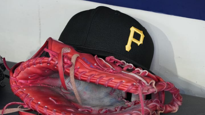 Jun 23, 2025; Milwaukee, Wisconsin, USA; against the Pittsburgh Pirates hat and glove in the dugout before a game against the Milwaukee Brewers at American Family Field. Mandatory Credit: Michael McLoone-Imagn Images