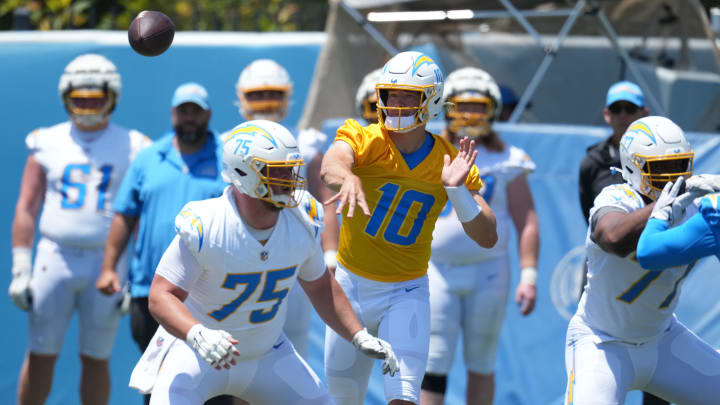 May 29, 2024; Costa Mesa, CA, USA; Los Angeles Chargers quarterback Justin Herbert (10) throws the ball as center Bradley Bozeman (75) and guard Zion Johnson (77) defend during organized team activities at Hoag Performance Center. Mandatory Credit: Kirby Lee-USA TODAY Sports May 29, 2024; Costa Mesa, CA, USA; Los Angeles Chargers quarterback Justin Herbert (10) throws the ball as center Bradley Bozeman (75) and guard Zion Johnson (77) defend during organized team activities at Hoag Performance Center. Mandatory Credit: Kirby Lee-USA TODAY Sports