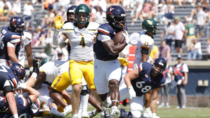 Sep 13, 2025; Charlottesville, Virginia, USA; Virginia Cavaliers running back Harrison Waylee (21) carries the ball to score a touchdown against the William & Mary Tribe during the second quarter at Scott Stadium. Mandatory Credit: Amber Searls-Imagn Images Sep 13, 2025; Charlottesville, Virginia, USA; Virginia Cavaliers running back Harrison Waylee (21) carries the ball to score a touchdown against the William & Mary Tribe during the second quarter at Scott Stadium. Mandatory Credit: Amber Searls-Imagn Images