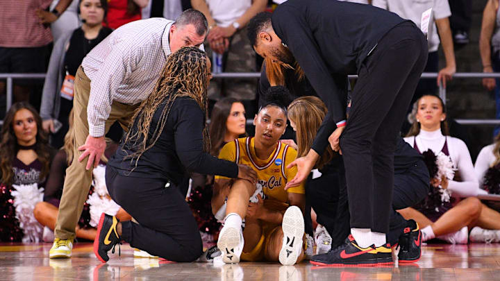 Watkins is looked after by trainers after being injured during Monday's women's NCAA tournament game.