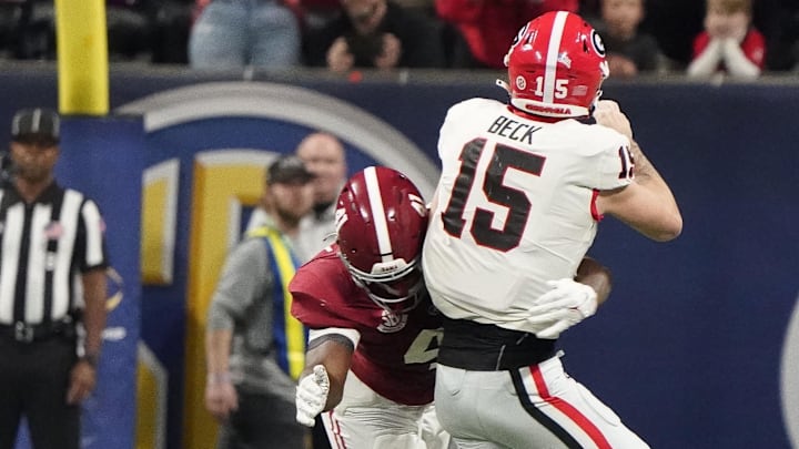 Dec 2, 2023; Atlanta, GA, USA;  Alabama Crimson Tide linebacker Chris Braswell (41) hits Georgia Bulldogs quarterback Carson Beck (15) as he throws, causing an incomplete pass at Mercedes-Benz Stadium. Alabama defeated Georgia 27-24 to claim the SEC Championship. Mandatory Credit: Gary Cosby Jr.-Imagn Images