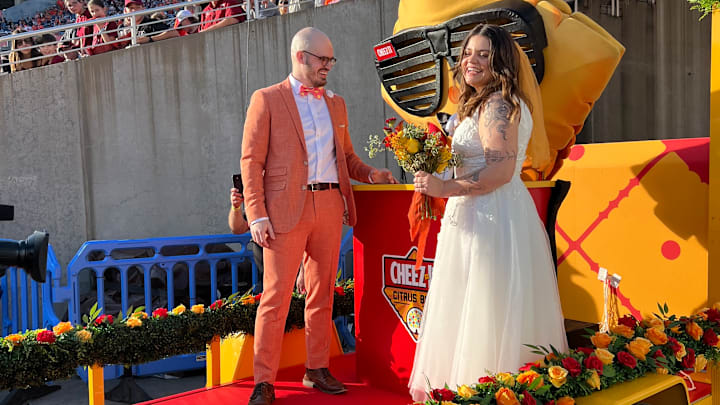Erik Yakes marries Erin Doolan during the Cheez-It Citrus Bowl in a ceremony officiated by Cheez-It mascot Ched-Z. Image courtesy Cheez-It