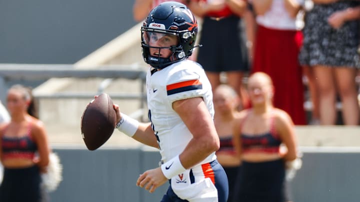 Sep 6, 2025; Raleigh, North Carolina, USA; Virginia Cavaliers quarterback Chandler Morris (4) runs with the football during the first half of the game against North Carolina State Wolfpack at Carter-Finley Stadium. Mandatory Credit: Jaylynn Nash-Imagn Images