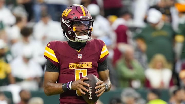 Sep 11, 2025; Green Bay, Wisconsin, USA;  Washington Commanders quarterback Jayden Daniels (5) during warmups prior to the game against the Green Bay Packers at Lambeau Field. 