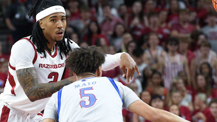 Arkansas Razorbacks guard Boogie Fland makes a pass defended by Kansas Jayhawks Zeke Mayo at Bud Walton Arena in Fayetteville, Ark.