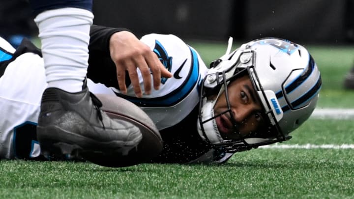 Dec 15, 2024; Charlotte, North Carolina, USA;  Carolina Panthers quarterback Bryce Young (9) fumbles the ball in the first quarter at Bank of America Stadium. Mandatory Credit: Bob Donnan-Imagn Images