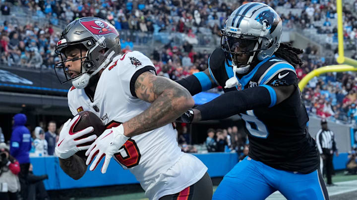 Dec 1, 2024; Charlotte, North Carolina, USA; Tampa Bay Buccaneers wide receiver Mike Evans (13) catches a touchdown as Carolina Panthers cornerback Jaycee Horn (8) defends in the first quarter at Bank of America Stadium. 