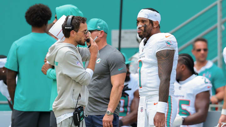 Miami Dolphins head coach Mike McDaniel and quarterback Tua Tagovailoa (1) stand on the sideline against the New England Patriots during the second quarter at Hard Rock Stadium. Miami Dolphins head coach Mike McDaniel and quarterback Tua Tagovailoa (1) stand on the sideline against the New England Patriots during the second quarter at Hard Rock Stadium.