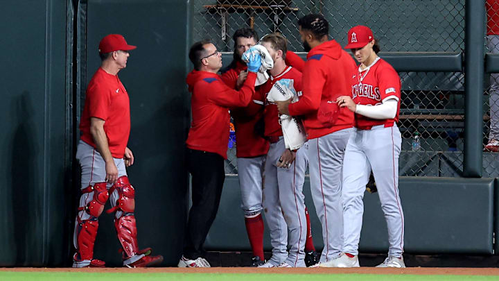 Aug 31, 2025; Houston, Texas, USA; Los Angeles Angels trainers attend to Los Angeles Angels left fielder Taylor Ward (3) after he sustained an injury while attempting to field a ball hit by Houston Astros second baseman Ramon Urias (29, not shown) during the eighth inning at Daikin Park. Mandatory Credit: Erik Williams-Imagn Images