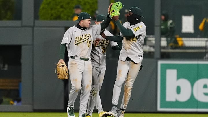 Apr 5, 2025; Denver, Colorado, USA; Athletics outfielder Seth Brown (15),outfielder JJ Bleday (33) and outfielder Lawrence Butler (4) celebrate defeating the Colorado Rockies at Coors Field. Mandatory Credit: Ron Chenoy-Imagn Images