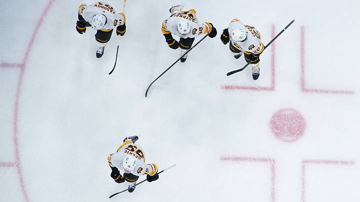 Apr 7, 2026; Raleigh, North Carolina, USA;  Boston Bruins center Morgan Geekie (39) celebrates his goal with center Elias Lindholm (28) right wing David Pastrnak (88) and  defenseman Nikita Zadorov (91) against the Carolina Hurricanes during the first period at Lenovo Center. Mandatory Credit: James Guillory-Imagn Images