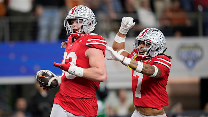 Ohio State Buckeyes defensive end Jack Sawyer (33) celebrates his touchdown return with Ohio State Buckeyes cornerback Jordan Hancock (7) against Texas Longhorns in the fourth quarter of the Cotton Bowl Classic during the College Football Playoff semifinal game at AT&T Stadium in Arlington, Texas on January, 10, 2025.