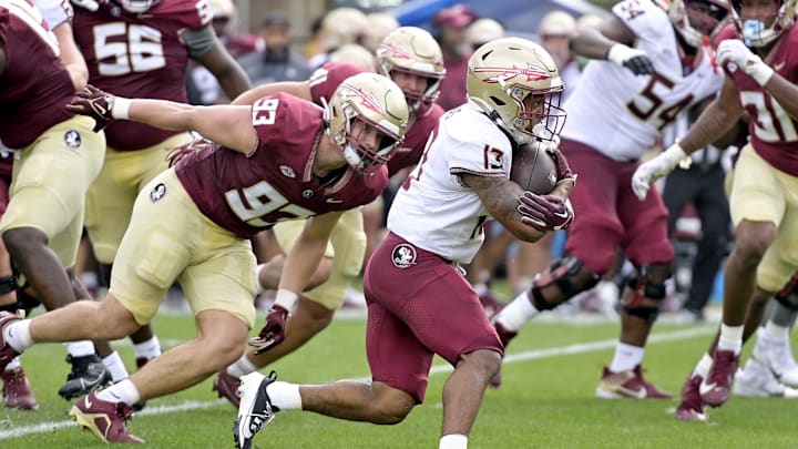 Apr 20, 2024; Tallahassee, Florida, USA; Florida State Seminoles running back Jaylin Lucas (13) runs with the ball during the Spring Showcase at Doak S. Campbell Stadium. Mandatory Credit: Melina Myers-Imagn Images