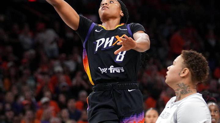 Phoenix Mercury guard Monique Akoa Makani (8) lays the ball up past Las Vegas Aces forward Kierstan Bell (1) during Game 3 of the WNBA Finals at Mortgage Matchup Center in Phoenix on Oct. 8, 2025.